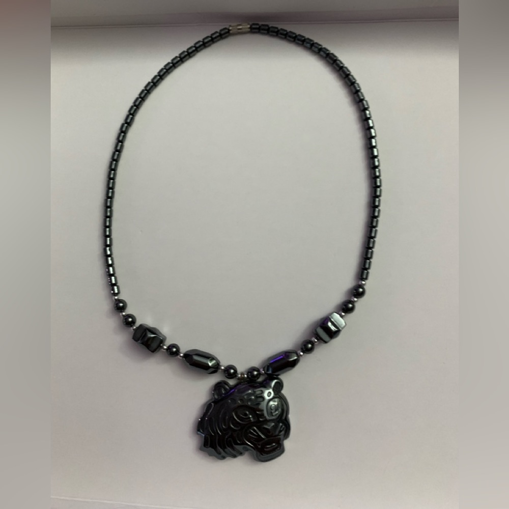 Hematite necklace with tiger head, 18” length.